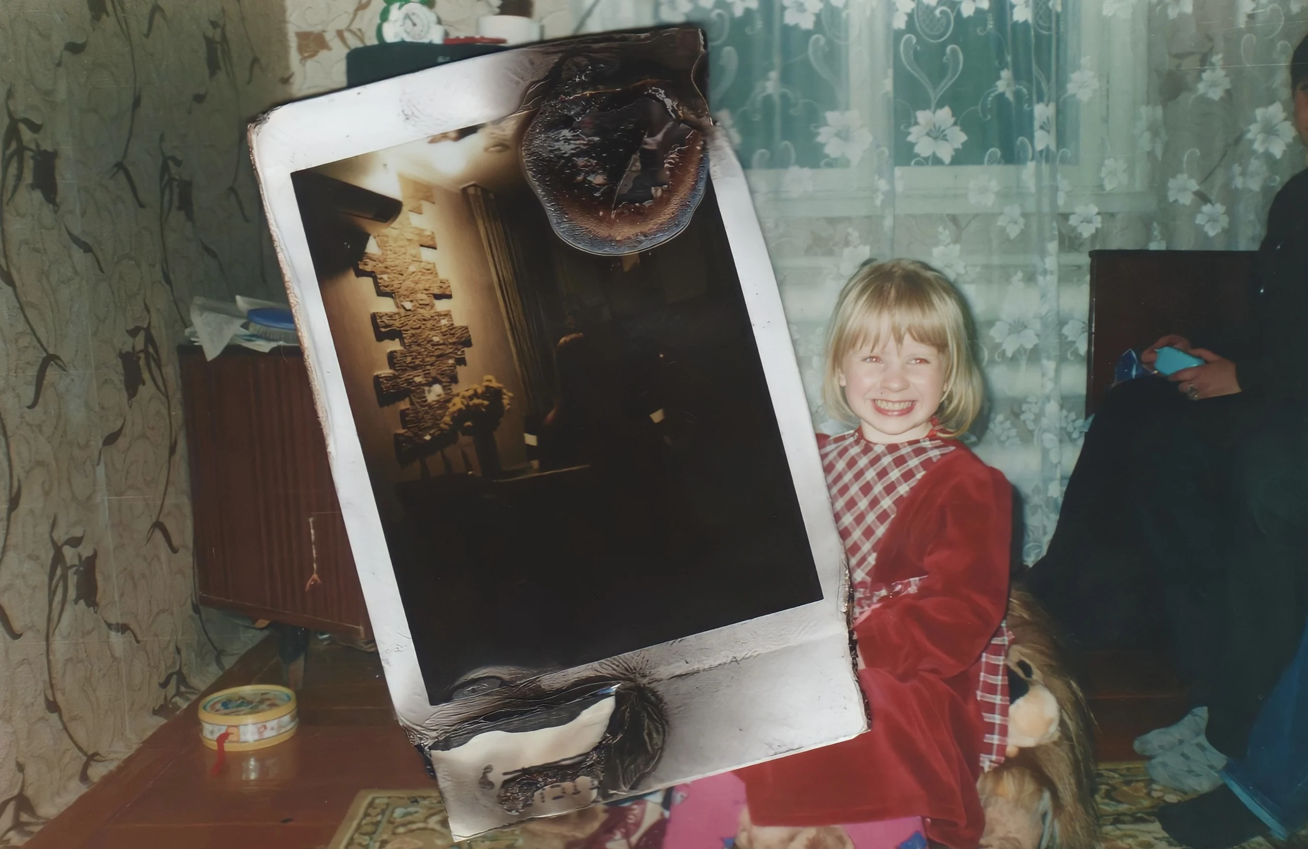 A childhood photo with a burnt polaroid laid over it