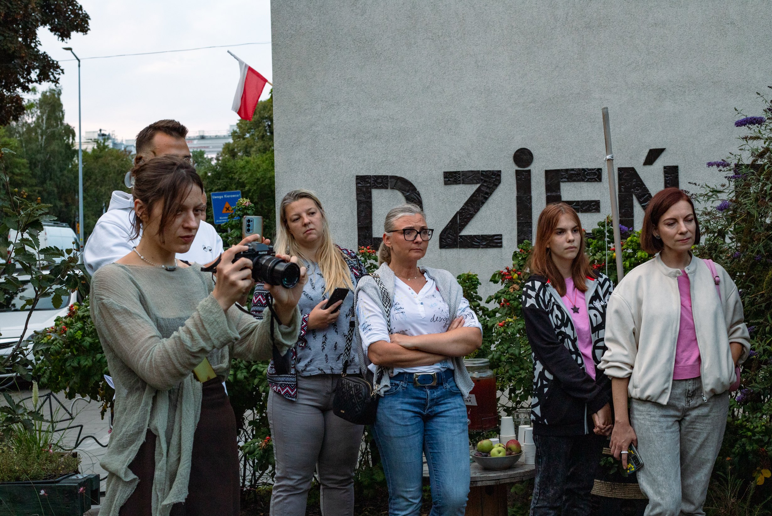 Visitors watching and photographing the performance